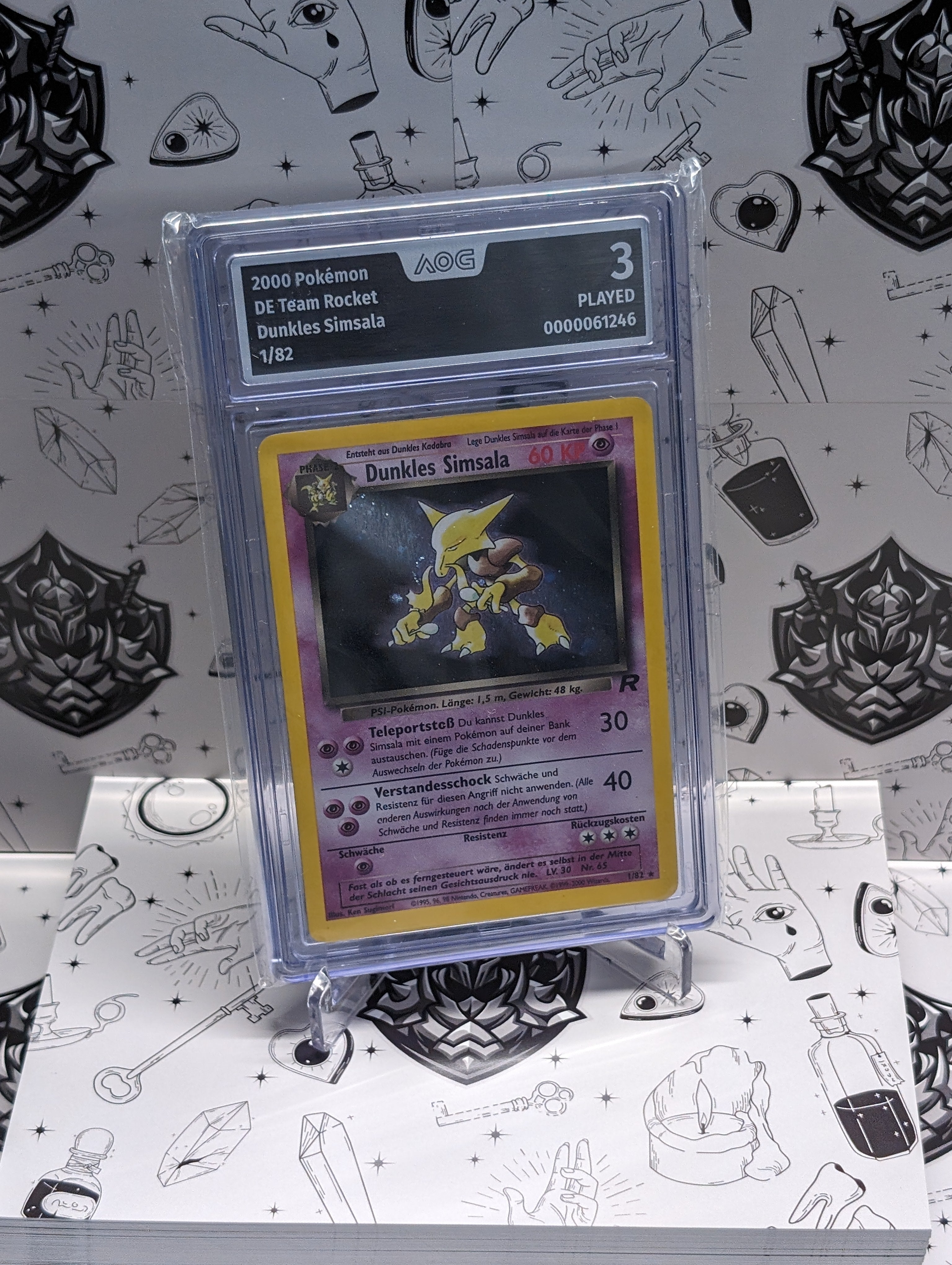 Dunkles Simsala 1/82 – Team Rocket – Deutsch – AOG Graded 3 – Holo Rare aus 2000.